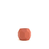 Terracotta-colored geometric pot on a white background