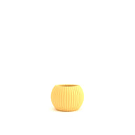 Yellow ribbed planter on a white background