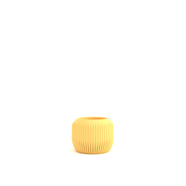 Yellow ribbed vase on a white background