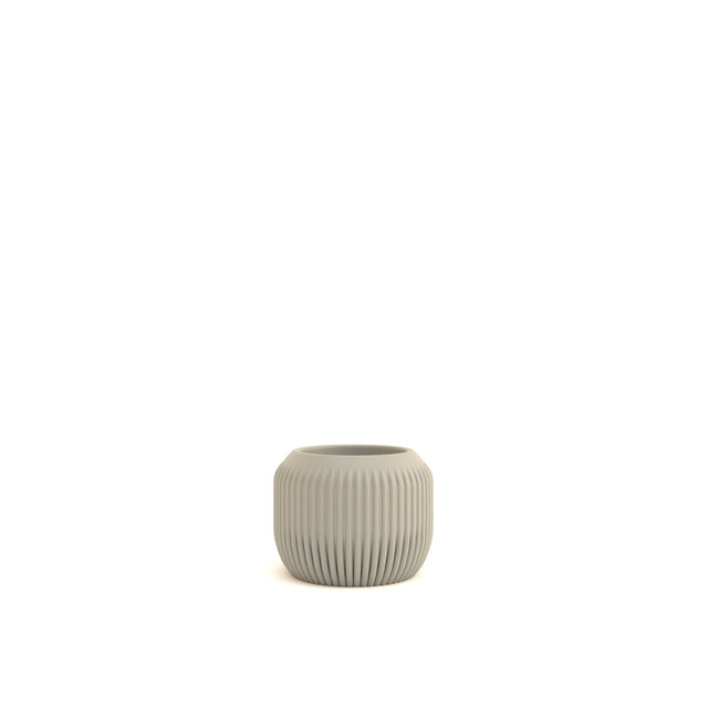 Small ribbed ceramic pot on a white background