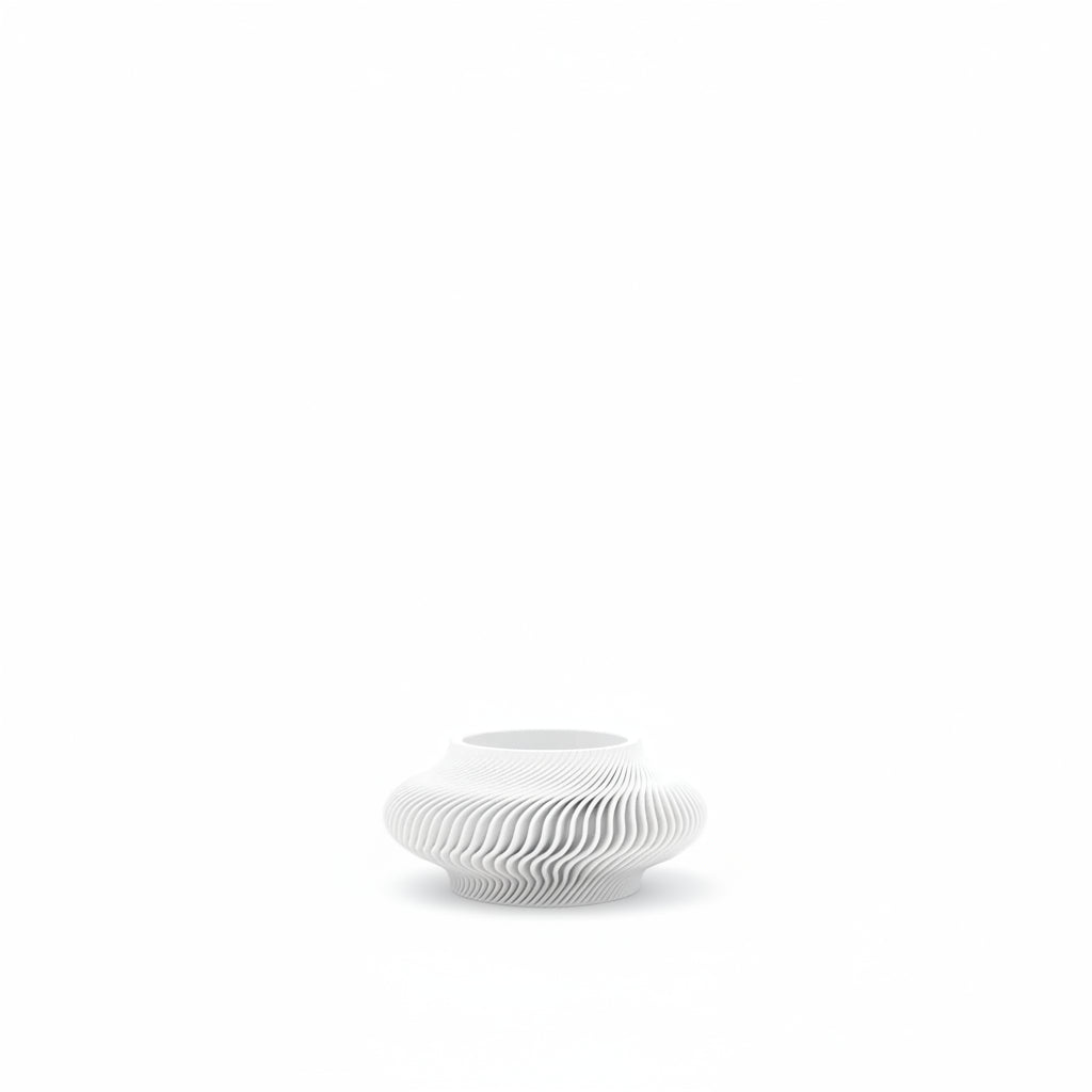 White ceramic vase with wavy design on a white background