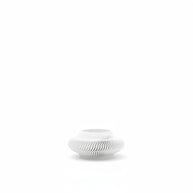 White ceramic vase with wavy design on a white background