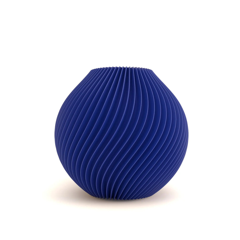 Blue ribbed spherical vase on a white background